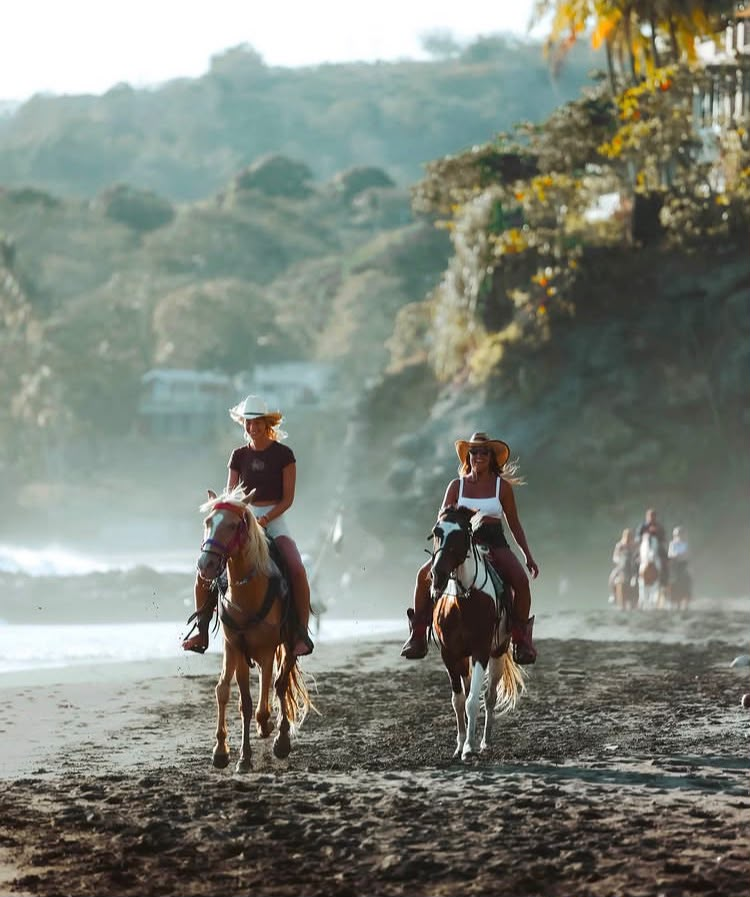 Horseback riders exploring the beautiful Surf City coastline