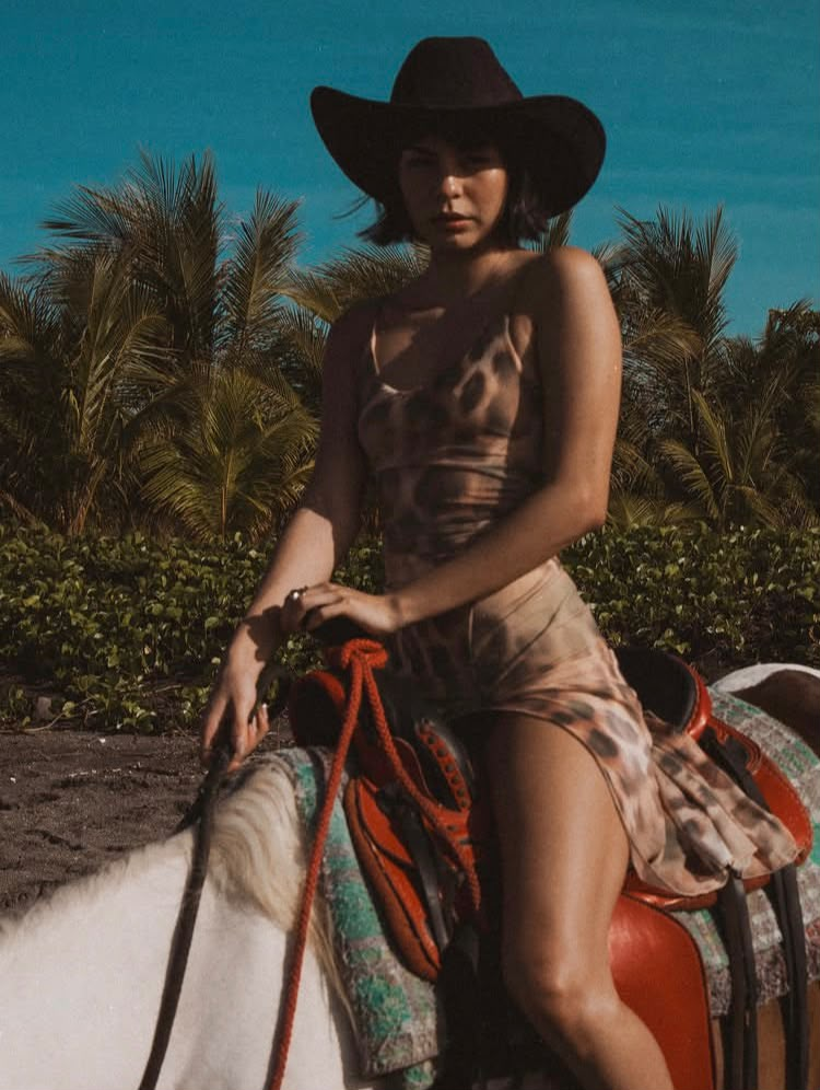 A rider in a black cowboy hat at Caballo Pinto Stables